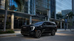 A premium full-size luxury black SUV arriving at a modern high-rise corporate office building in downtown Jacksonville, Florida.